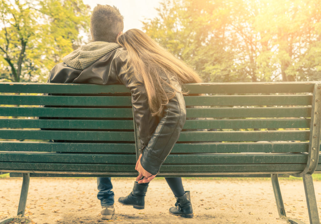 couple sitting on a bench - date night keeping relationships alive