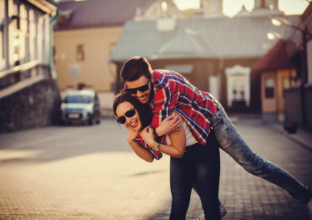 woman giving man a piggy back ride - signs you're ready for a committed relationship