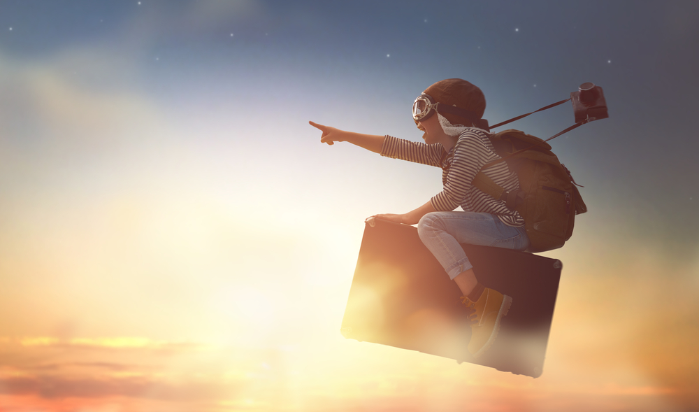 kid flying in the sky on a suitcase - what do our dreams mean?