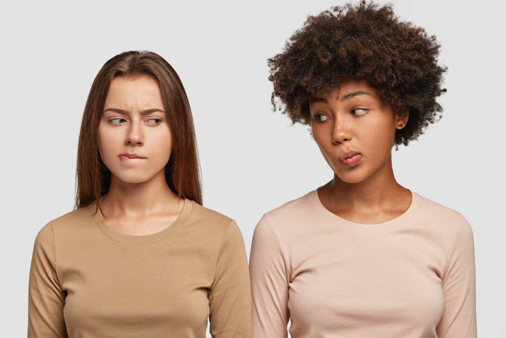two women giving each other faces - signs of a bad relationship