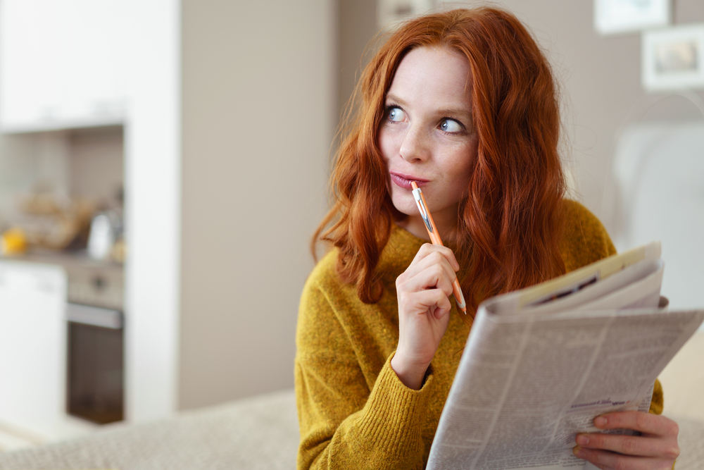 woman completing a crossword puzzle to increase mental fitness