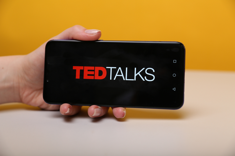 hand holding a phone with best ted talks to watch