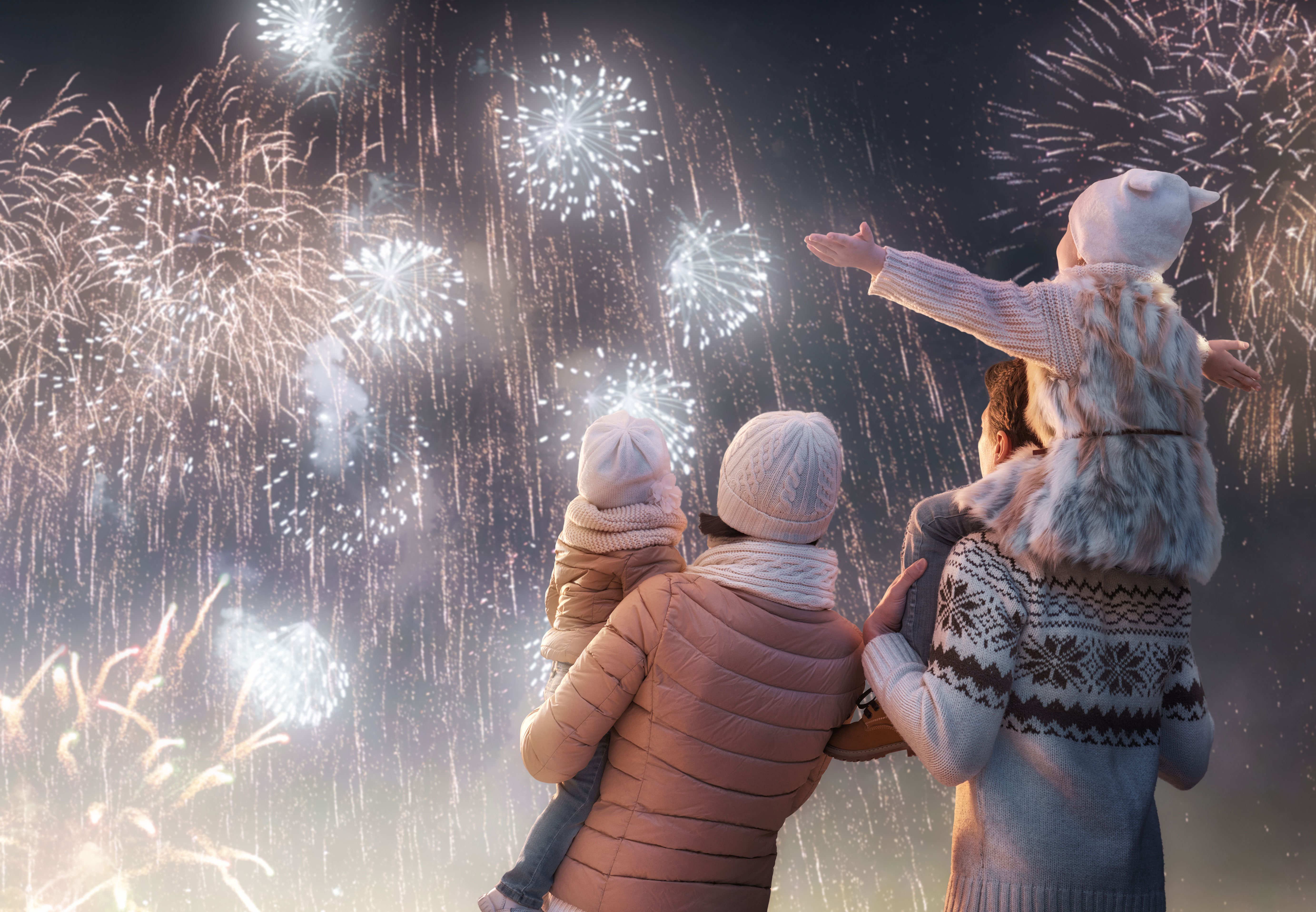 an image of a married couple with two kids looking up at fireworks as each of them aspires to be a better giver