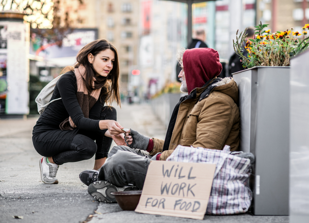 woman giving beggar money