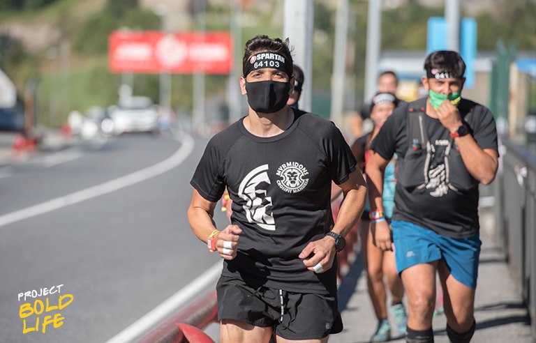 A group of people running with masks on