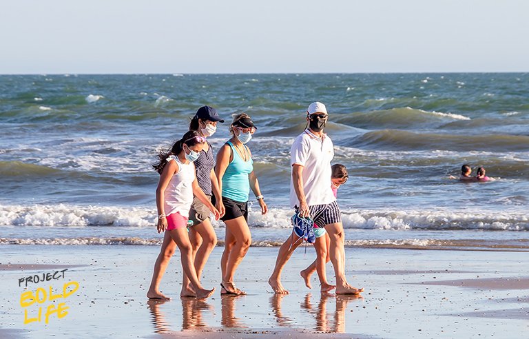 A family walking on the beach, embracing change