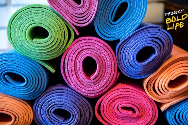 A bunch of yoga mats stacked up