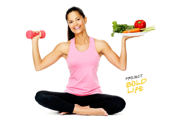 A woman about to eat a dumbell with veggies