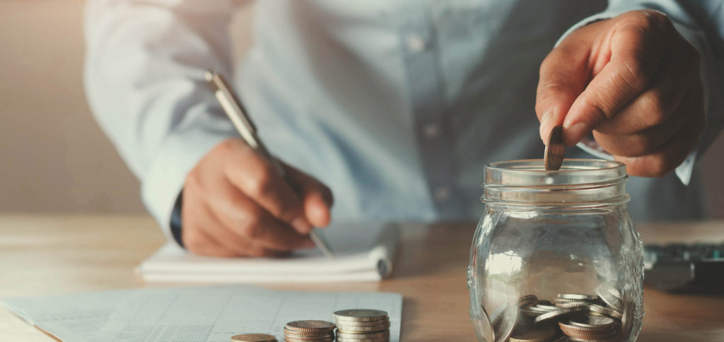 calculating monthly budget and putting savings in jar