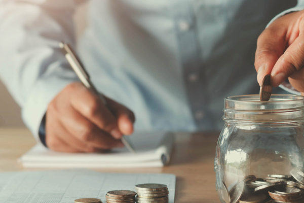calculating monthly budget and putting savings in jar