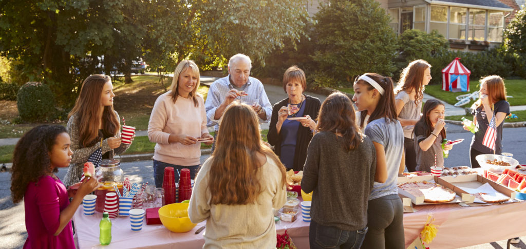 group of people enjoying a neighborhood block party outside