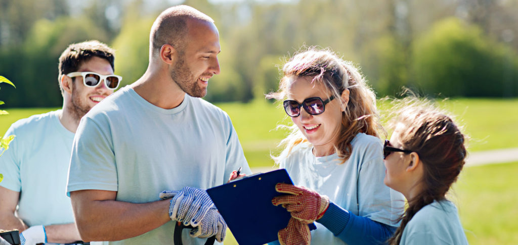 group of people giving back to the community by picking up trash