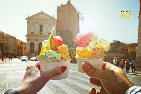 couple holding Italian ice-cream in Rome, Italy - cities for foodies