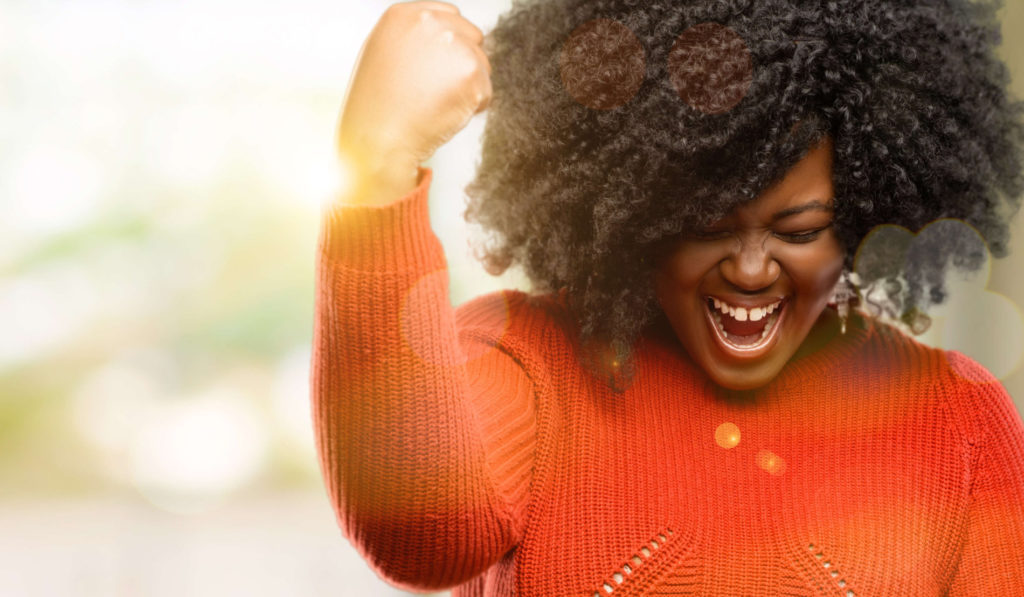 Woman smiling with her fist in the air