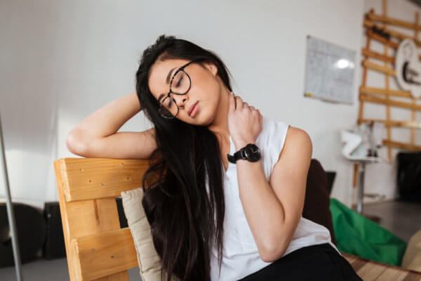 girl holding stress in her neck - needs to know how manage stress levels