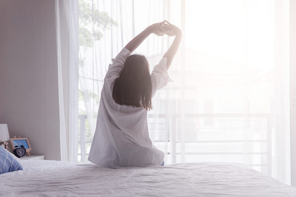 girl waking up in the morning after a good night's sleep