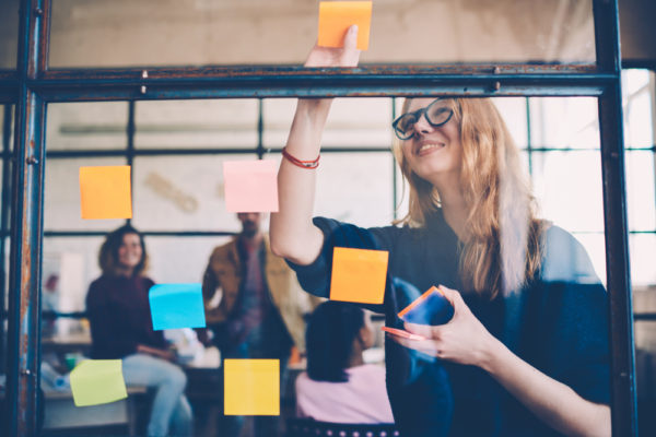 Girl organizing her day with sticky notes