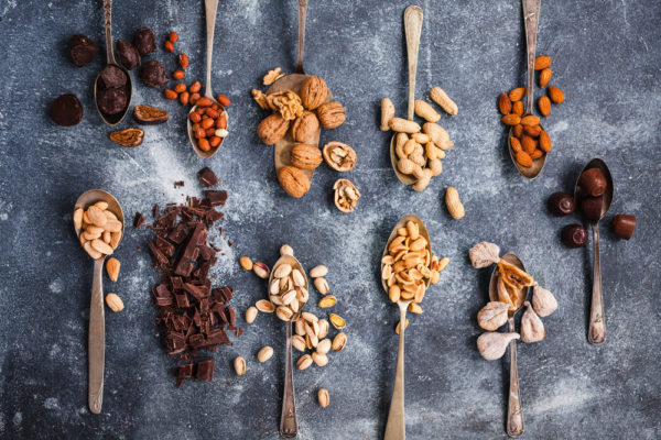 spoons full of chocolate and nuts - foods that cause migraines