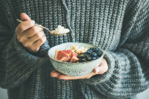 woman holding a bowl of real food for detox diet