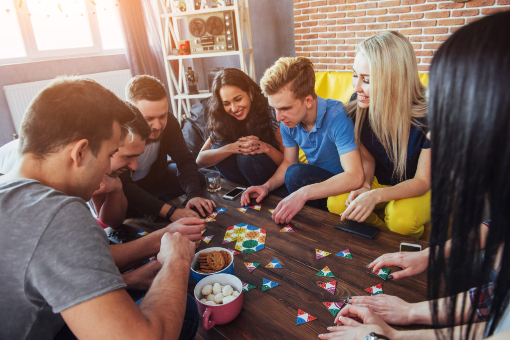 group of adults playing fun board games