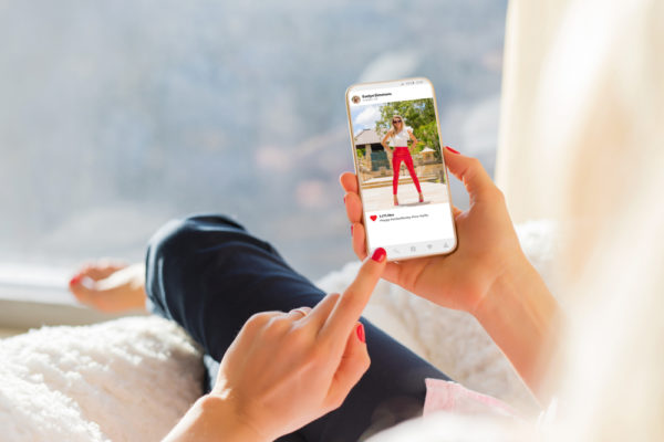woman scrolling through social media on her phone