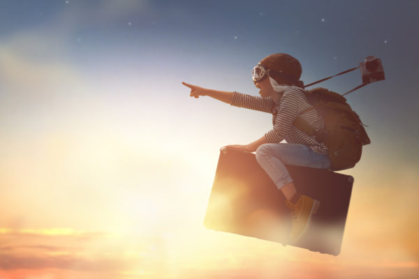 kid flying in the sky on a suitcase - what do our dreams mean?