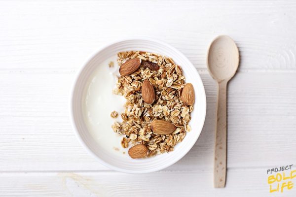 bowl of greek yogurt, almonds and oats - all good foods to eat before bed