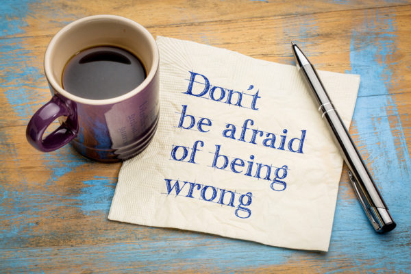a coffee cup and note about being wrong