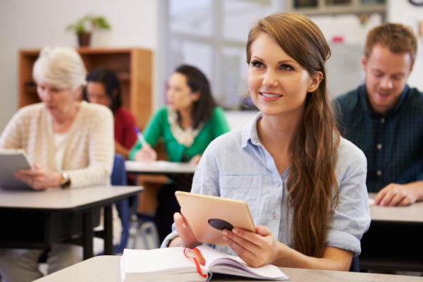 woman going back to school with notebook and a tablet