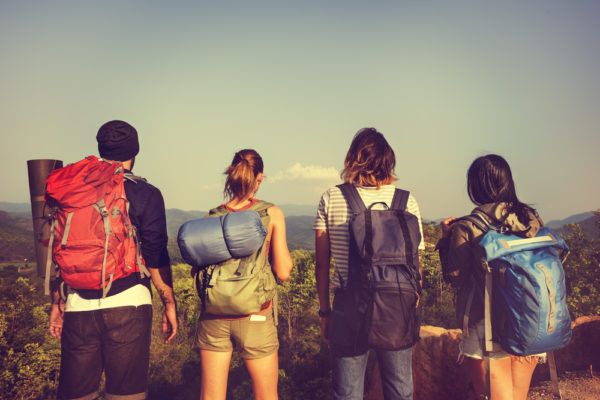 group of four travelers with different types of backpacks on - what kind of traveler are you?