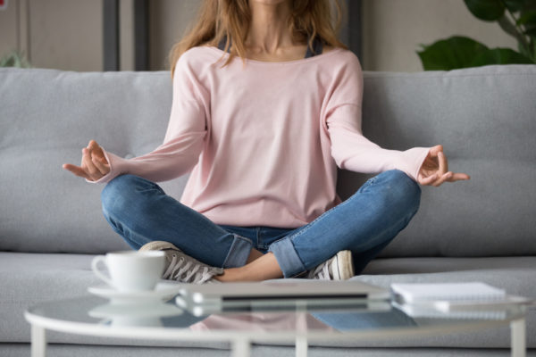 girl on couch practicing mindfulness as a natural way to combat anxiety