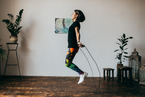 girl doing an at-home workout by jump roping