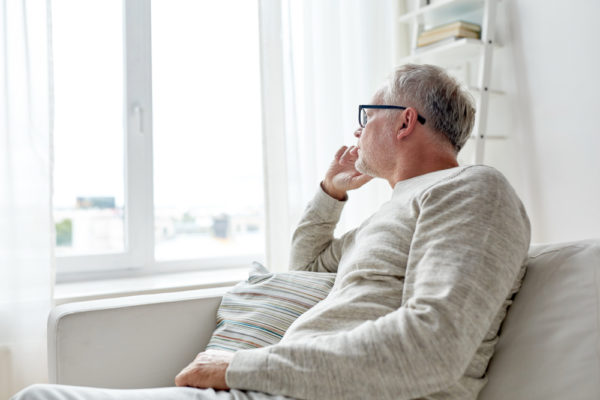 man looking out the window wondering how to deal with a midlife crisis