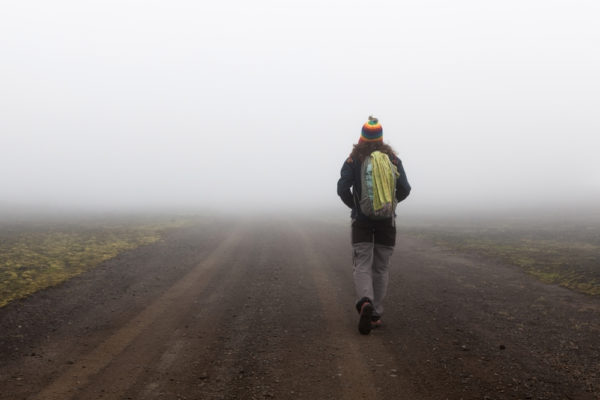 middle of nowhere, woman walking in a foggy place