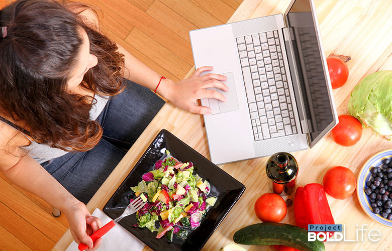someone working and eating a salad