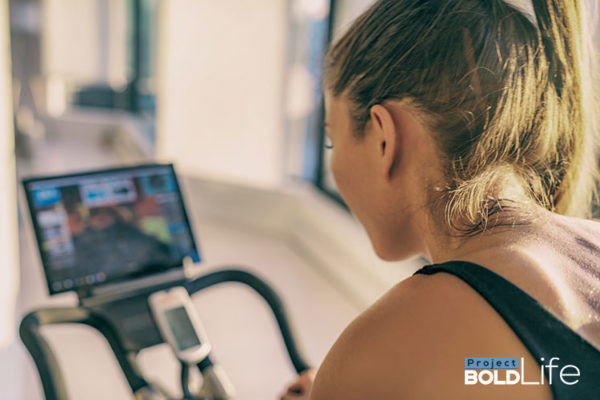 A woman riding an exercise bike