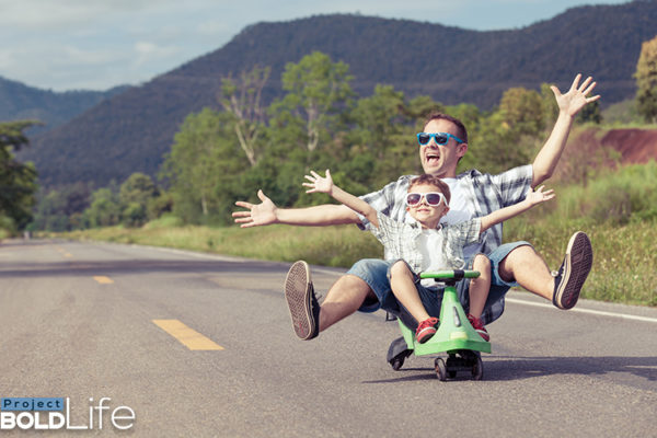 A dad and his kid driving down the highway in an illegal vehicle