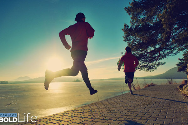 A couple running along the water reducing their stress