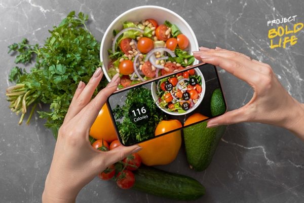 Someone using their phone to analyze their food