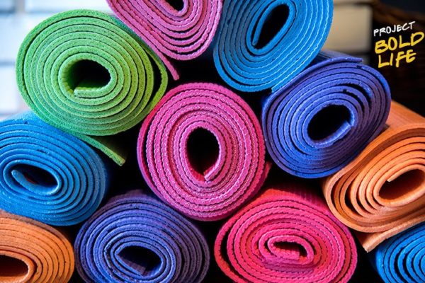 A bunch of yoga mats stacked up