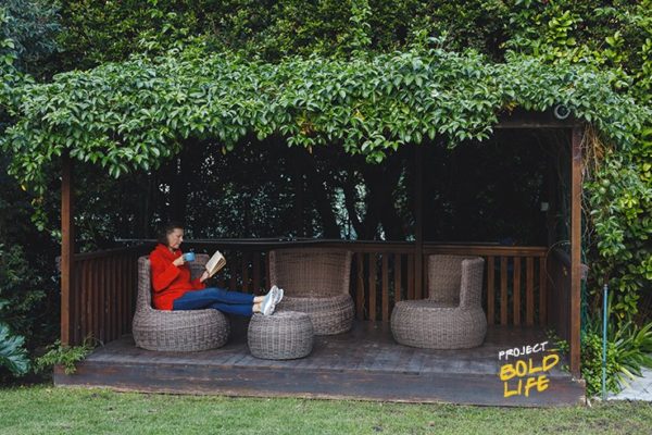 A woman just chilling alone in her backyard