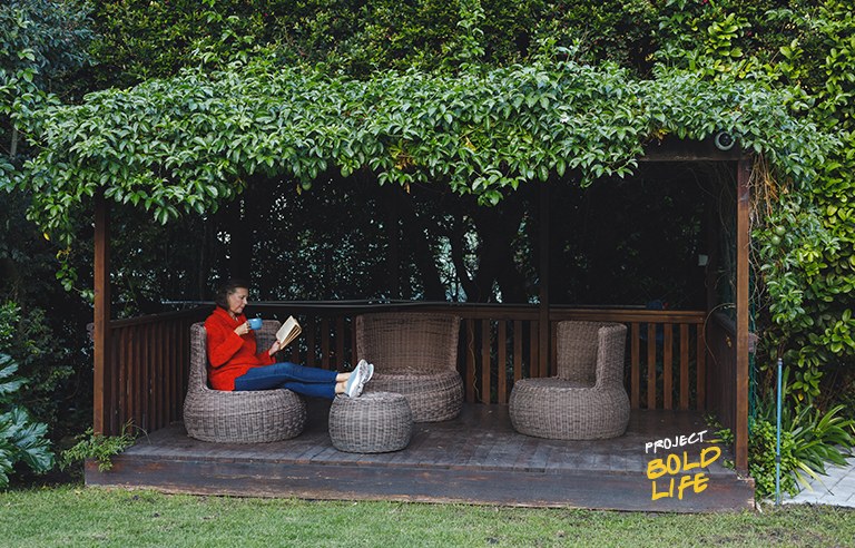 A woman just chilling alone in her backyard