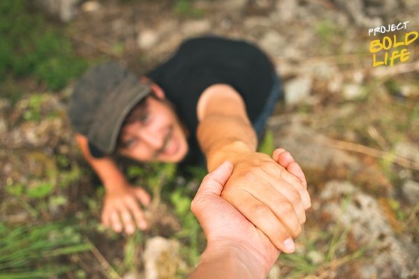 some dude hanging precariously
