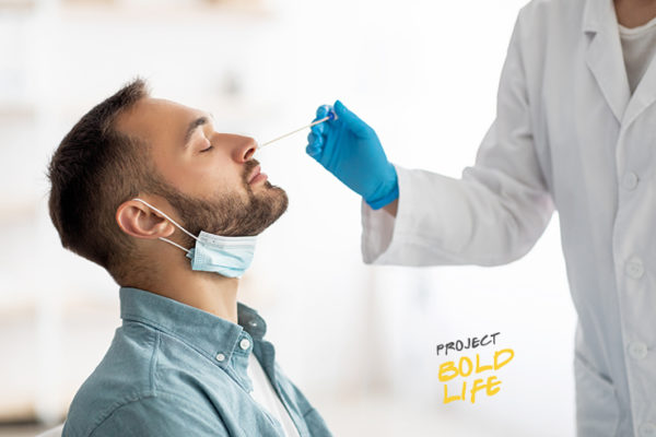 Some dude getting his nose swabbed