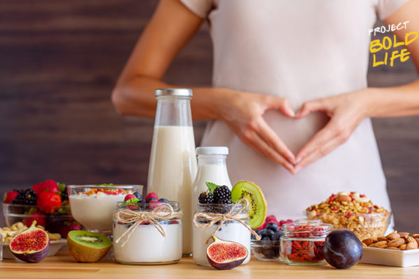 A woman standing before some food