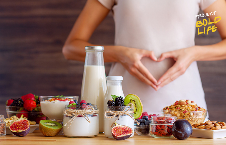 A woman standing before some food