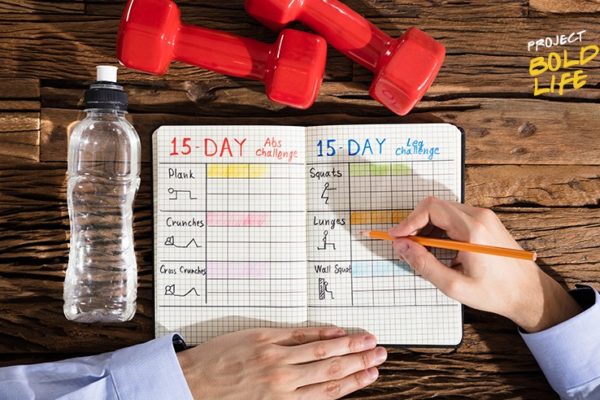 Someone writing down their workout plan
