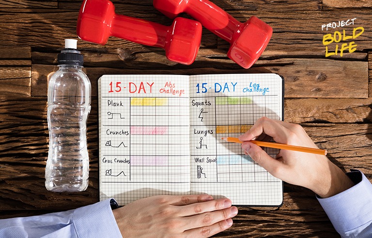 Someone writing down their workout plan