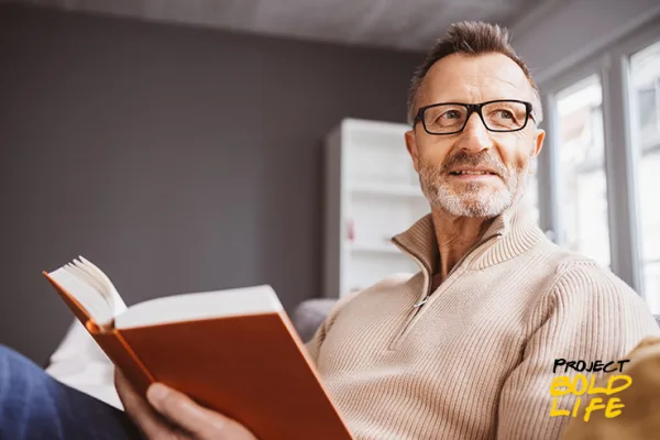 A dude reading the Best Self-Improvement Books For 2023