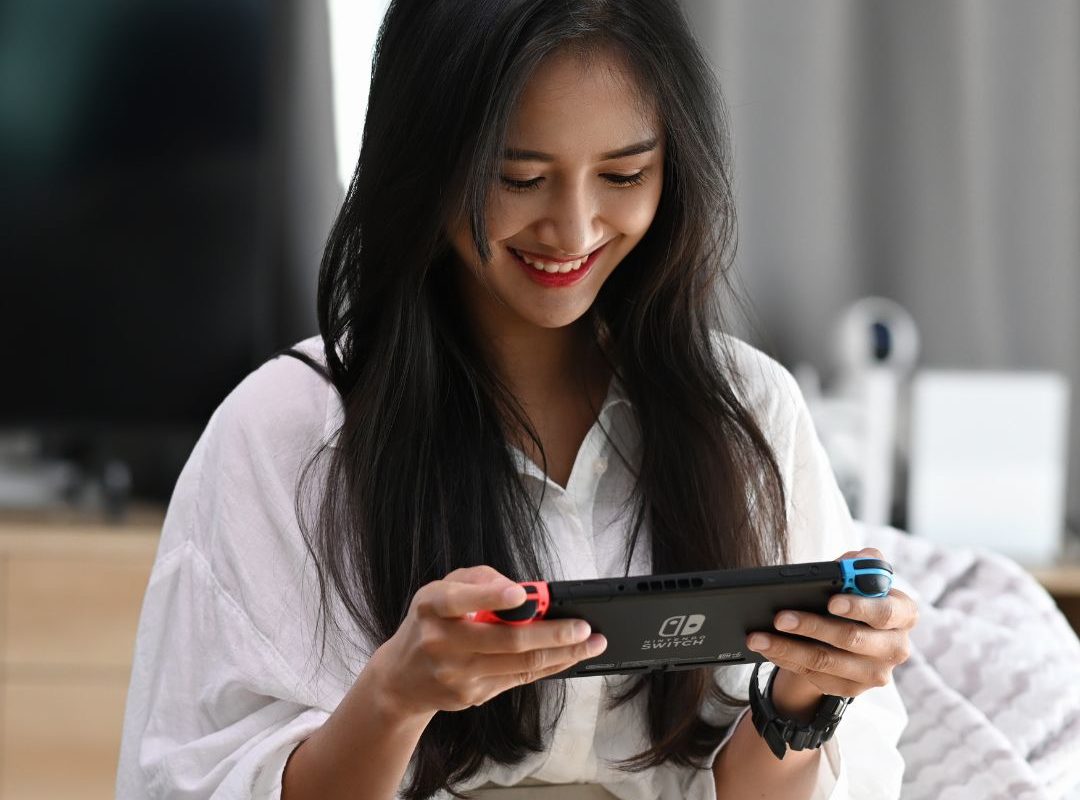 a woman pondering the Best Christmas gifts for gamers 2024